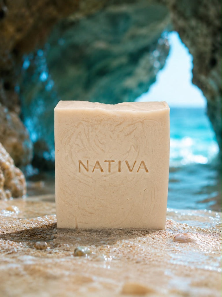 NATIVA handcrafted natural soap bar resting on ocean rocks in Puerto Rico